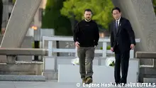 Ukrainian President Volodymyr Zelenskiy and Japanese Prime Minister Fumio Kishida, leave the Cenotaph for the Victims of the Atomic Bomb following laying flowers at the Hiroshima Peace Memorial Park, after Zelenskiy was invited to the Group of Seven nations' summit in Hiroshima, western Japan, Sunday, May 21, 2023. Eugene Hoshiko/Pool via REUTERS
