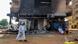 A man walks past a burnt out bank branch in southern Khartoum on May 24, 2023. A man walks past a burnt out bank branch in southern Khartoum on May 24, 2023.