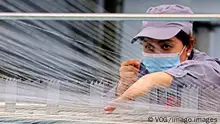 AKSU, CHINA - MARCH 31: An employee operates a weaving loom at a textile factory on March 31, 2021 in Aksu, Xinjiang Uygur Autonomous Region of China. PUBLICATIONxINxGERxSUIxAUTxHUNxONLY Copyright: xVCGx CFP111324132899