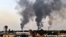 24/05/2023 TOPSHOT - Smoke rises above buildings in Khartoum on May 24, 2023. Fighting had eased but not stopped in Sudan on May 24, the second full day of a ceasefire that has allowed beleaguered civilians to venture out, even as they await safe aid corridors and escape routes. (Photo by AFP) (Photo by -/AFP via Getty Images)