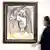 Picasso's 'Buste de femme' from 1971 on show at the Van Ham auction house in Cologne, with woman walking by the painting.