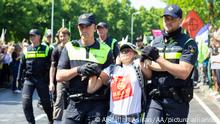 THE HAGUE, NETHERLANDS - MAY 27: Police officers arrest the demonstrators after protesting, organized by the group called Extinction Rebellion, for an end to the use of fossil fuels at A12 road in the Hague, Netherlands on May 27, 2023. Abdullah Asiran / Anadolu Agency