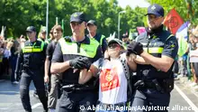 THE HAGUE, NETHERLANDS - MAY 27: Police officers arrest the demonstrators after protesting, organized by the group called Extinction Rebellion, for an end to the use of fossil fuels at A12 road in the Hague, Netherlands on May 27, 2023. Abdullah Asiran / Anadolu Agency