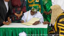 In this photo released by the Nigeria State House, Nigeria's new President Bola Ahmed Tinubu, signs a document after taking the oath of office at a ceremony in Abuja Nigeria, Monday May 29, 2023. Tinubu has been sworn in as president of Africa's most populous country at a period of unprecedented challenges, leaving some citizens hopeful for a better life and others skeptical that his government would perform better than the one he succeeded. (Sunday Aghaeze/Nigeria State House via AP)