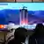 A TV screen shows a file image of North Korea's rocket launch