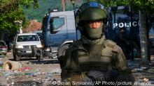 30/05/2023**KFOR soldiers, front, and Kosovo police officers guard a municipal building after yesterday's clashes between ethnic Serbs and troops from the NATO-led KFOR peacekeeping force, in the town of Zvecan, northern Kosovo, Tuesday, May 30, 2023. The violence was the latest incident as tensions soared over the past week, with Serbia putting the country's military on high alert and sending more troops to the border with Kosovo, which declared independence from Belgrade in 2008. (AP Photo/Dejan Simicevic)