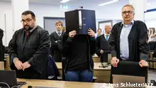 31.05.2023***The defendant Lina E. (C) and her lawyers Erkan Zunbul (L) and Ulrich von Klinggraeff (R) stand in the courtroom at the higher regional court in Dresden, eastern Germany, on May 31, 2023. (Photo by JENS SCHLUETER / AFP) 