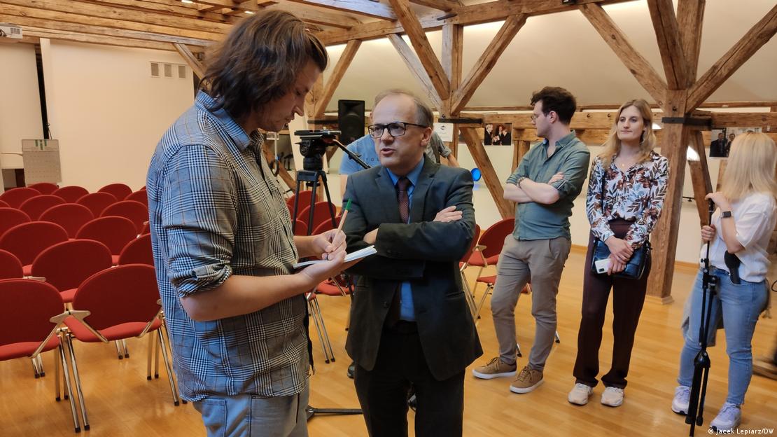 Director of the German Historical Institute Warsaw, Milos Reznik (center), speaks to a journalist after the disturbance, German Historical Institute, Warsaw, Tuesday, May 30, 2023