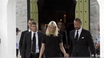Norway's Crown Prince Haakon, right, and his wife Mette-Marit leave the church after a memorial service in Norderhov, Norway, Sunday, July 24, 2011. A Norwegian dressed as a police officer gunned down at least 84 people at an island youth retreat before being arrested, police said Saturday. Investigators are still searching the surrounding waters, where people fled the attack, which followed an explosion in nearby Oslo that killed seven. (Foto:Frank Augstein/AP/dapd)