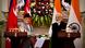 Pushpa Kamal Dahal and Narendra Modi stand next to each other at lecterns Pushpa Kamal Dahal and Narendra Modi stand next to each other at lecterns