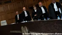 06/06/2023 *** Presiding judge Joan Donoghue, center, and other judges enter the World Court in The Hague, Netherlands, Tuesday, June 6, 2023. Four days of hearings opened in a case brought by Ukraine against Russia at the UN's top court alleging that Russia breached treaties on terrorist financing and racial discrimination in eastern Ukraine and Crimea. (AP Photo/Peter Dejong)