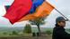 An Armenian protester holding a flag at the Armenian-Azerbaijani border An Armenian protester holding a flag at the Armenian-Azerbaijani border