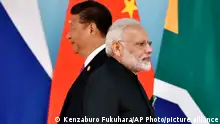 Chinese President Xi Jinping, left, and Indian Prime Minister Narendra Modi attend the group photo session at 2017 BRICS Summit in Xiamen, Fujian province in China, Monday, Sept. 4, 2017. (Kenzaburo Fukuhara/Pool Photo via AP)