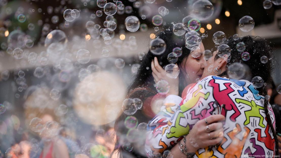 A couple kisses under soap bubbles as they take part in a Pride Parade in Pristina, Kosovo, June 10, 2023