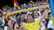 A Ukrainian fan holds up a scarf that reads "glory to Ukraine" A Ukrainian fan holds up a scarf that reads "glory to Ukraine"