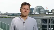 DW's Philipp Falkenstein is seen reporting from Berlin's government district.
