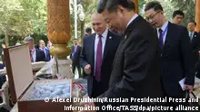 DUSHANBE, TAJIKISTAN - JUNE 15, 2019: Russia's President Vladimir Putin (L) presents China's President Xi Jinping with Russian ice cream as he congratulates the Chinese leader on his 66th birthday. Alexei Druzhinin/Russian Presidential Press and Information Office/TASS