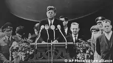**FILE** In this June 26, 1963 file photo President John F. Kennedy delivers his famous speech I am a Berliner (ich bin ein Berliner) in front of the city hall in West Berlin. Far right is the mayor in office of West Berlin Willy Brandt. In contrast to Reagan's five-hour visit in 1987, Kennedy's visit is remembered quite differently. He stood in front of a city building in the Schoeneburg neighborhood and declared Ich bin ein Berliner, a legendary statement of solidarity with besieged West Berliners, who greeted him with exultation. (AP Photo)