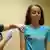 A girl receives an injection of the HPV vaccine from a female nurse