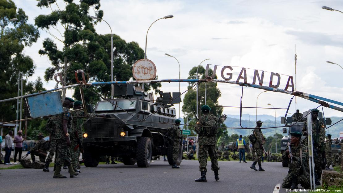 Members of the Uganda Peoples' Defence Forces (UPDF) position themselves on the Ugandan side of the border town in Bunagana, Democratic Republic of Congo