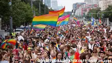 TOPSHOT - Participants of the Equality parade wave rainbow colored flags as they celebrate in the streets of Warsaw, Poland, on June 17, 2023. (Photo by Wojtek Radwanski / AFP) (Photo by WOJTEK RADWANSKI/AFP via Getty Images)