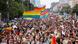 a sea of people, with many waving the rainbow flag a sea of people, with many waving the rainbow flag