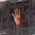 Detainee puts hand through window bars in Monrovia Central Prison (Photo: Bonnie Allen)