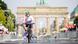 A cyclist competes in Berlin, with the Brandenburg Gate in the background A cyclist competes in Berlin, with the Brandenburg Gate in the background