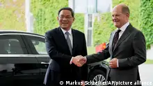 German Chancellor Olaf Scholz, right, welcomes Chinese Premier Li Qiang for a meeting at the Chancellery in Berlin, Germany, Monday, June 19, 2023. (AP Photo/Markus Schreiber)