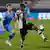 Youssoufa Moukoko grimaces as he kicks the ball in a game against Israel