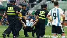 15.06.2023+++ Soccer Football - Friendly - Argentina v Australia - Workers' Stadium, Beijing, China - June 15, 2023
A pitch invader is taken off the pitch by security officials during the match REUTERS/Thomas Peter