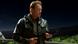 A man with a leather jacket and a sawn-off shotgun stands in the dark. A man with a leather jacket and a sawn-off shotgun stands in the dark.