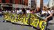 People holding a banner reading: 'No justice, no peace for Lamine Dieng'