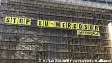 Illustration picture shows a banner saying 'Stop EU-Mercosur' during a protest action of Greenpeace environmental activists at the European Council building, Thursday 25 May 2023, in Brussels. Greenpeace activists gathered to protest against the proposed trade agreement between the EU and four South American Mercosur countries (Argentina, Brazil, Paraguay and Uruguay). For the NGO, the text conflicts with the European Green Deal. Greenpeace is particularly concerned about the different sanitary standards between the partners, especially concerning European pesticides, some of which are banned in the EU but legal in South America. BELGA PHOTO ADRIAN BURTIN