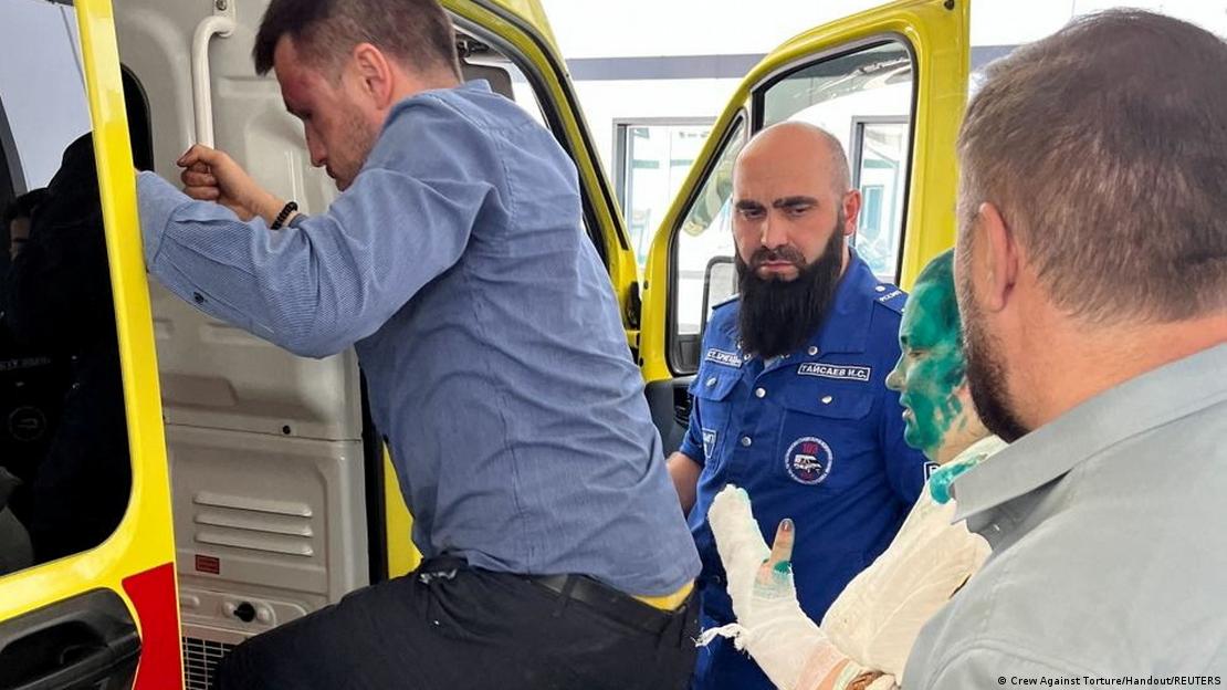 Elena Milashina getting into an ambulance at the hospital after they were attacked on their way