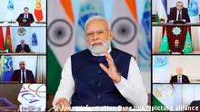 This photograph released by India government's Press Information Bureau shows Indian Prime Minister Narendra Modi, center address a virtual summit of the Shanghai Cooperation Organization, Tuesday, July 4, 2023. (Press Information Bureau via AP)