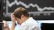 A trader scratches his head at the stock market in Frankfurt A trader scratches his head at the stock market in Frankfurt