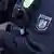 A close up shot of a North Rhine-Westphalia police officer's arm patch and handcuffs