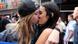 Same-sex couple celebrate with a kiss Same-sex couple celebrate with a kiss