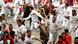 People running ahead of bulls in Pamplona People running ahead of bulls in Pamplona
