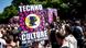 A person celebrates at the "Rave the Planet" techno parade with a poster reading -techno is my culture for UNESCO heritage- A person celebrates at the "Rave the Planet" techno parade with a poster reading -techno is my culture for UNESCO heritage-