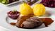 Sauerbraten — marinaded meat with dumplings on a plate Sauerbraten — marinaded meat with dumplings on a plate