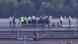 Group of police standing behind mesh fence at airport Group of police standing behind mesh fence at airport