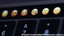 13.04.2022
Emojis are seen displayed on MacBook Pro touchbar in this illustration photo taken in Krakow, Poland on April 13, 2022. (Photo Illustration by Jakub Porzycki/NurPhoto)