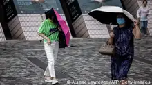 17.07.2023
People walk near Victoria Harbour as Typhoon Talim passes near Hong Kong on July 17, 2023. (Photo by ISAAC LAWRENCE / AFP) (Photo by ISAAC LAWRENCE/AFP via Getty Images)