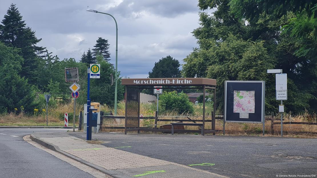 A bus stop with trees in the background