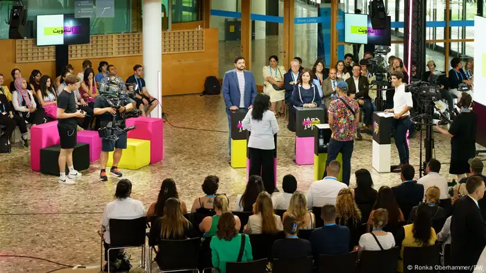 At panel is seen speaking at a production of DW's JaafarTalk program during the DW Global Media Forum in 2023