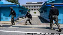 09/05/2023**In this photo taken on May 9, 2023, South Korean soldiers change positions at the truce village of Panmunjom in the Joint Security Area (JSA) of the Demilitarized Zone (DMZ) separating North and South Korea, with a view of North Korea's Panmon Hall (back C). South Korea and Japan's efforts to improve their once-strained relationship and boost military ties are key to countering North Korea, America's top general said. (Photo by Anthony WALLACE / AFP) (Photo by ANTHONY WALLACE/AFP via Getty Images)