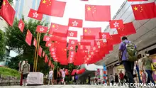 HONG KONG, CHINA - JUNE 29: People walk along a road decorated with China and Hong Kong flags celebrating the 26th anniversary of Hong Kong s return to the motherland on June 29, 2023 in Hong Kong, China. PUBLICATIONxINxGERxSUIxAUTxHUNxONLY Copyright: xChinaxNewsxServicex 111443376659