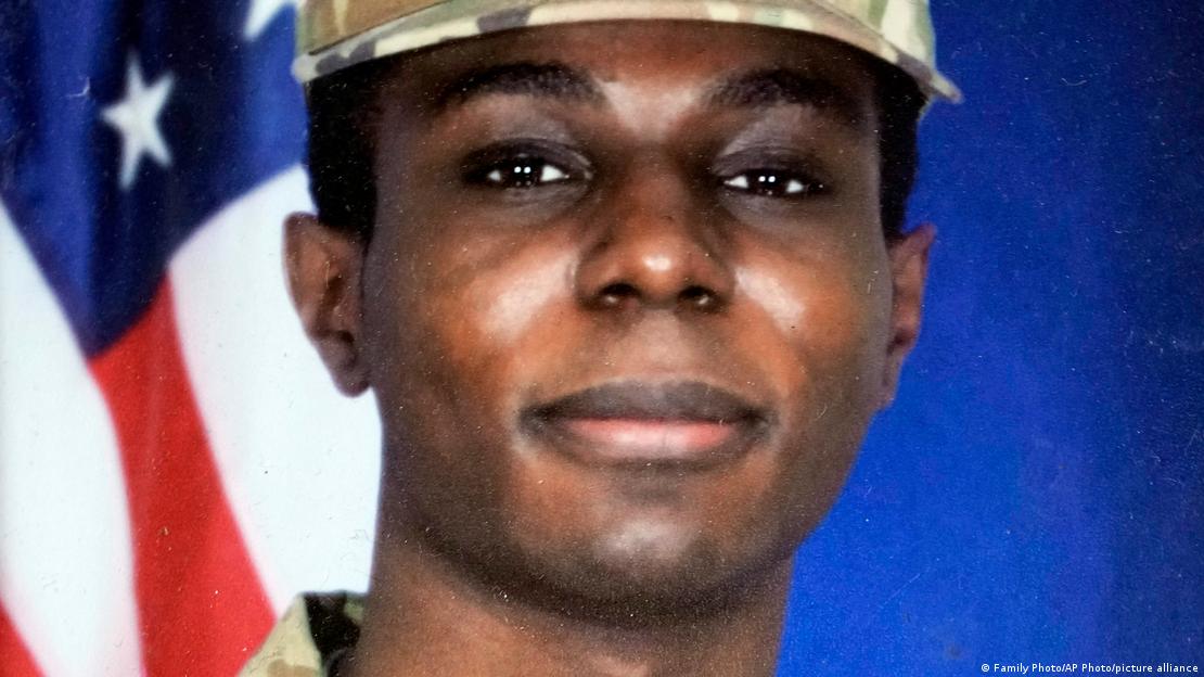 A man in a military hat with a blue background 